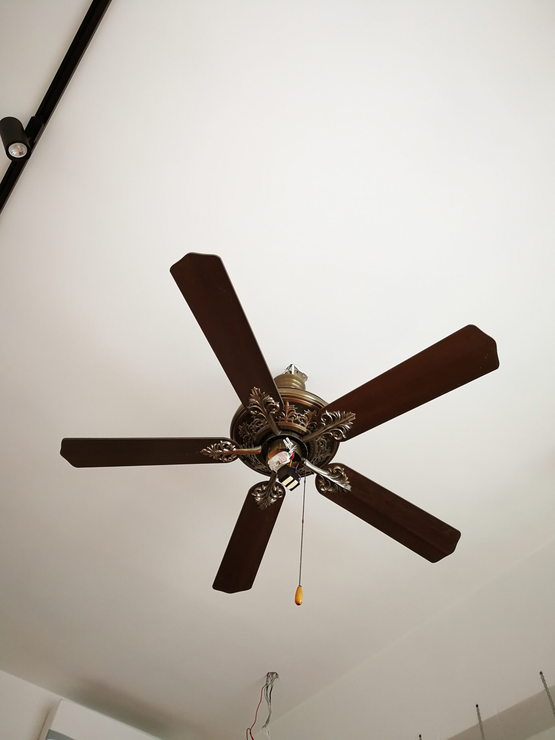 wooden ceiling fan being installed